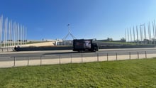 An advertising truck drives past Parliament House in Canberra