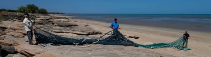 World Animal Protection team members on Gulf of Carpentaria with long fishing net.