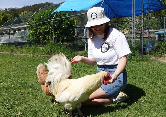 Hannah Smart, Communications Manager - Australia Aotearoa New Zealand, with chickens